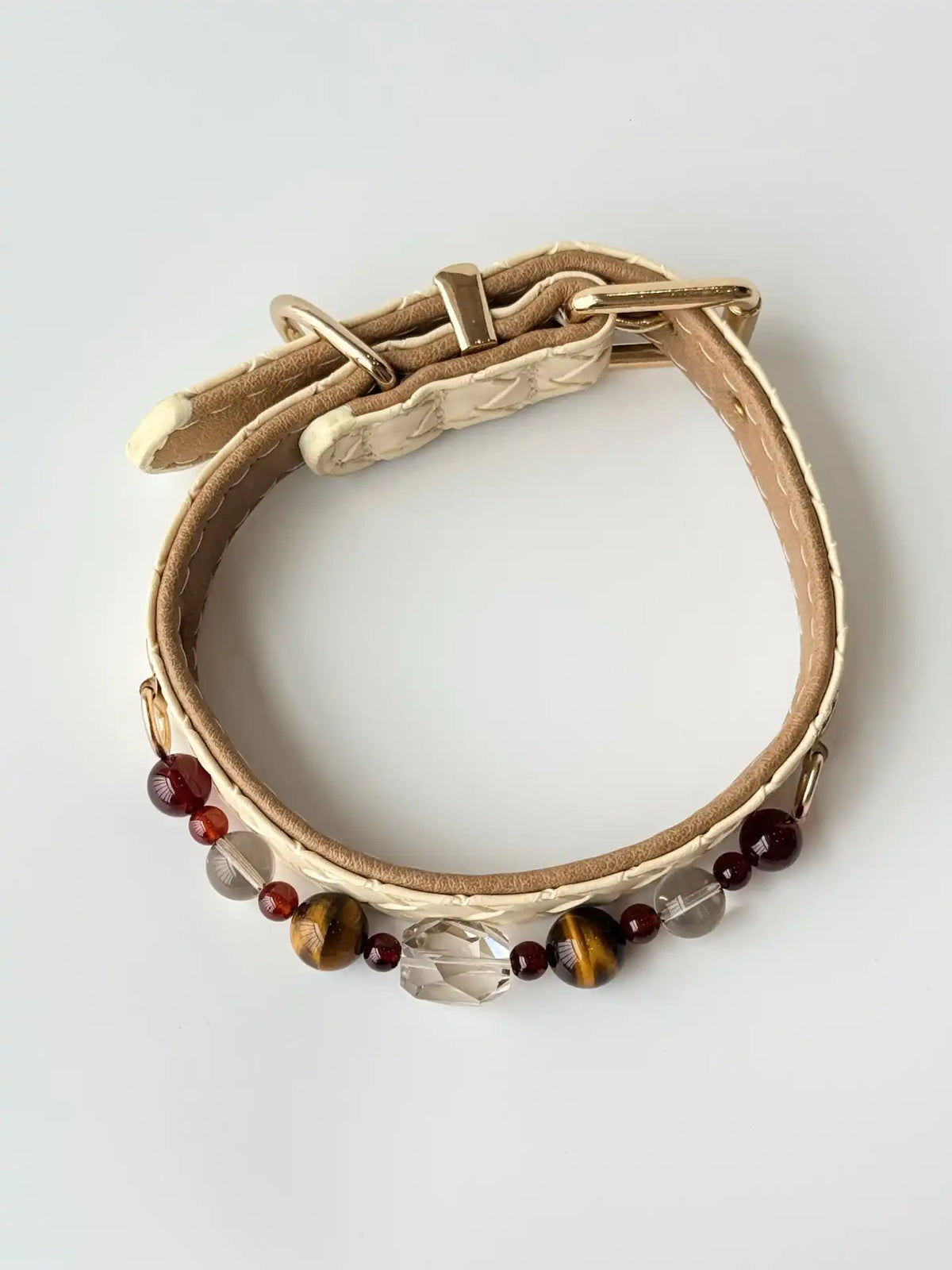 cat wearing cream woven leather collar with tiger eye crystal chain