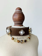 cat wearing brown leather collar with citrine garnet crystal chain