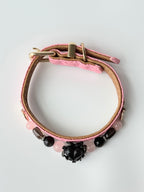 cat wearing pink woven leather collar with black obsidian heart charm
