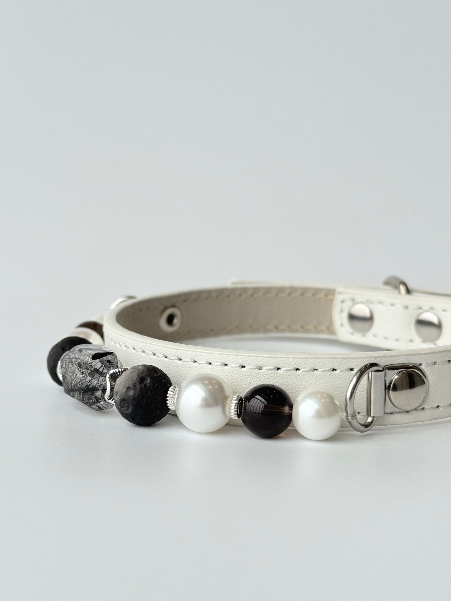 premium white leather pet collar with rutilated crystal leaf and pearl chain lifestyle photo