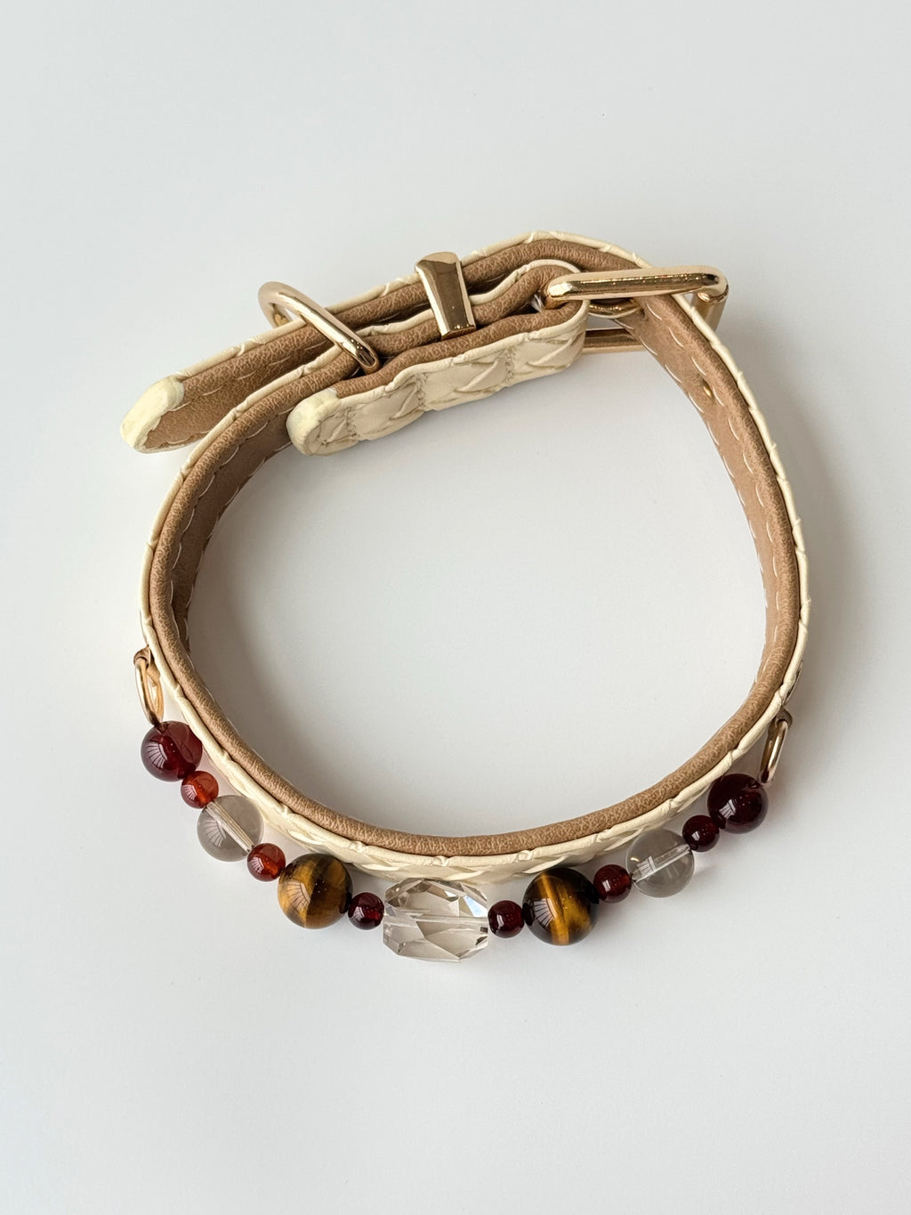 cat wearing cream woven leather collar with tiger eye crystal chain